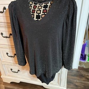 This is a shiny woven shirt than shimmers in the light perfect for New Years Eve